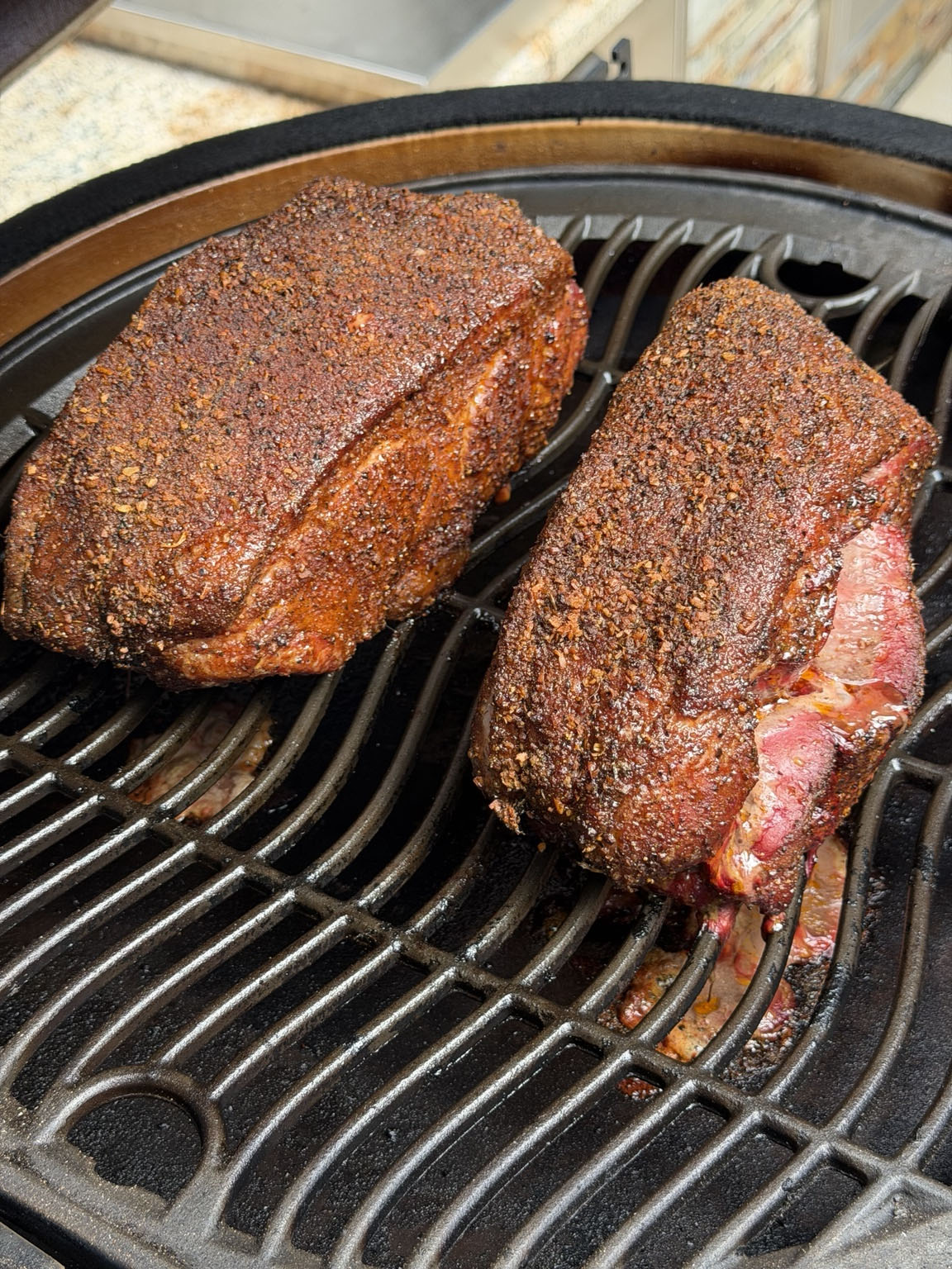 Seasoned barbecue roasts cooking over the grill